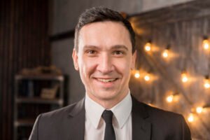 smiling man suit looking camera